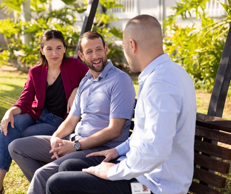 colleagues sitting on a bench and discussing work