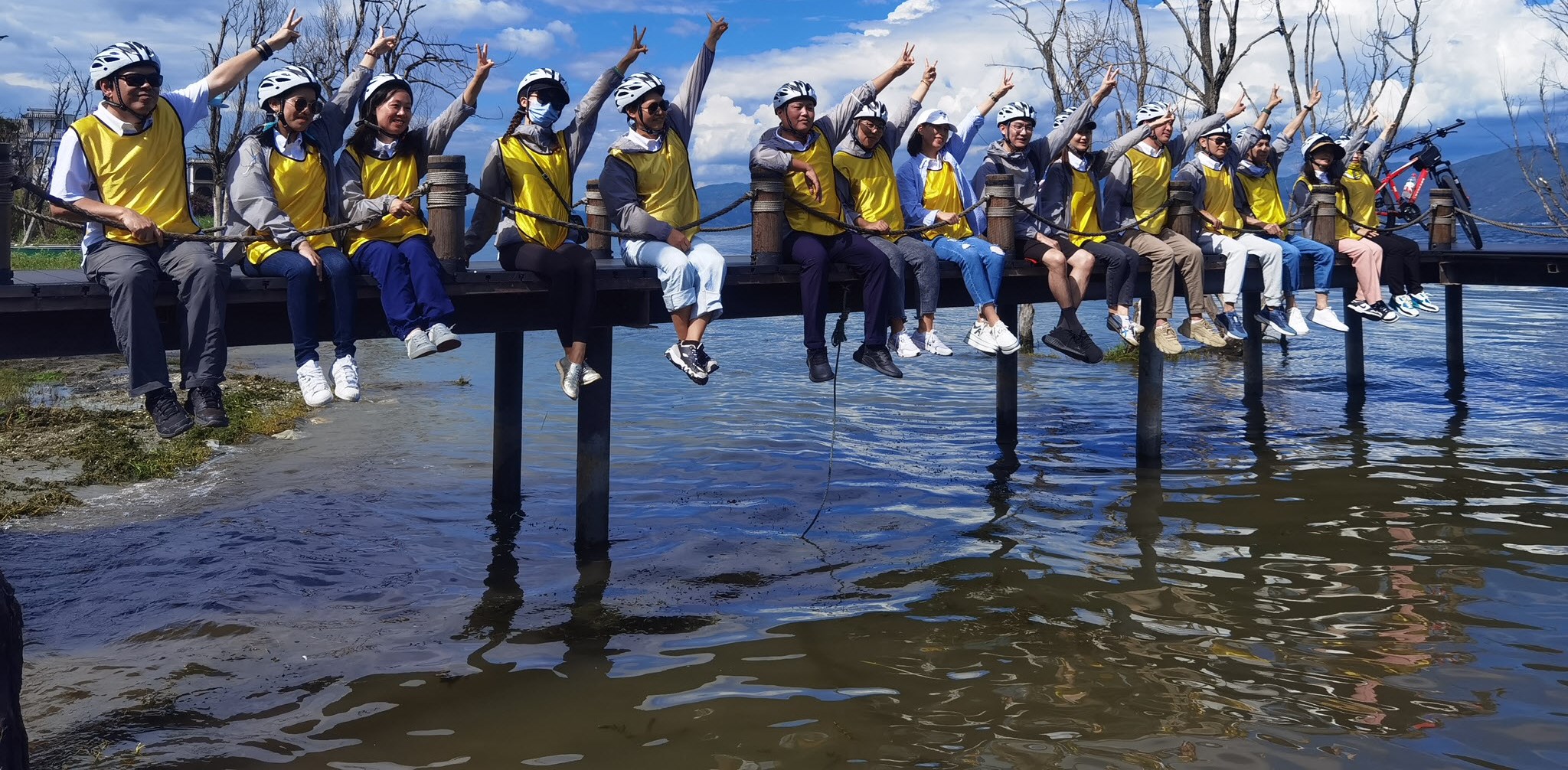 Teva employees raising hands outside in Dali