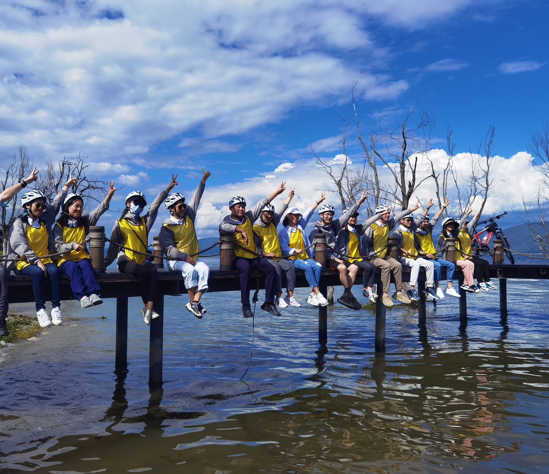 Teva employees raising hands outside in Dali